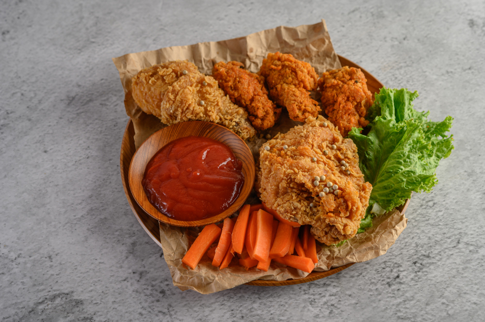 crispy-fried-chicken-wooden-plate-with-tomato-sauce-carrot