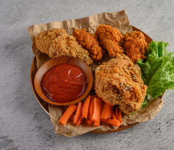 crispy-fried-chicken-wooden-plate-with-tomato-sauce-carrot